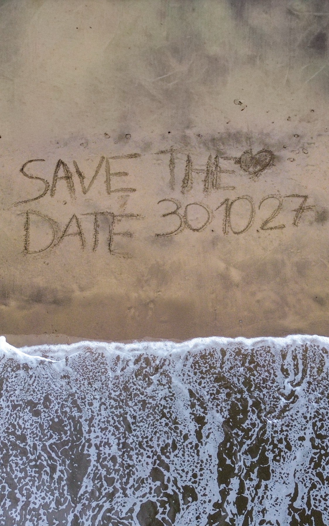 Save the date escrito en la arena